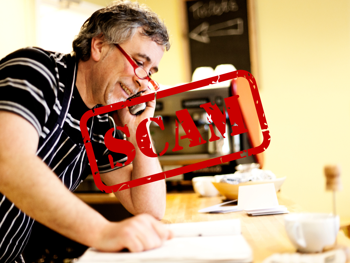 A man on the phone at his cafe